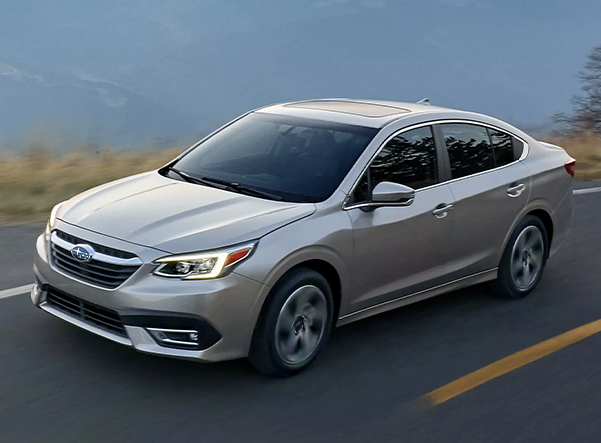 Silver Subaru Sedan driving down the road