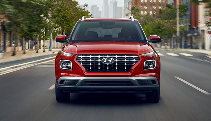 front view of the 2022 Hyundai Venue driving down the street