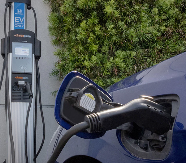 Electric Honda plugged into a charging station