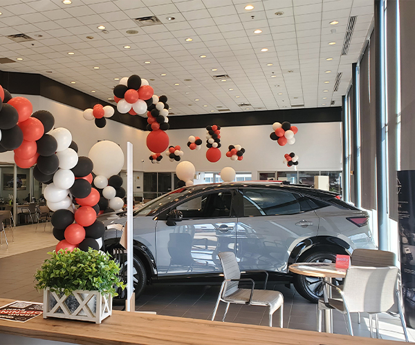 Car in the dealership surrounded by balloons