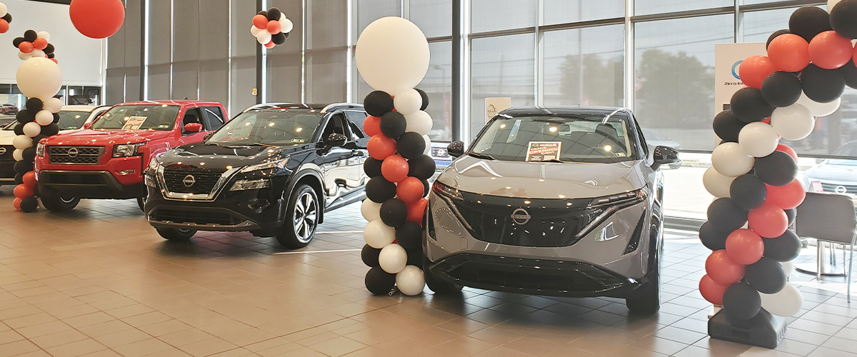 Vehicle lineup inside the dealership with decorative balloons