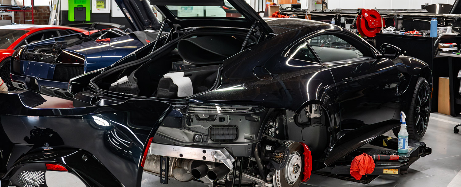 Rear shot of Aston Martin being disassembled