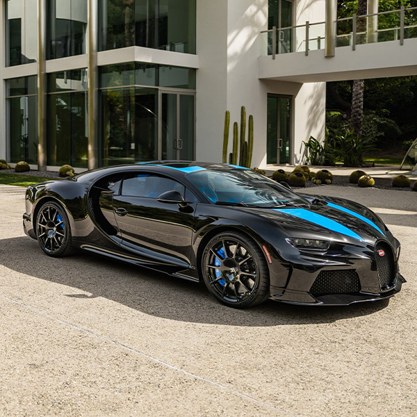 3/4 Profile view of a Bugatti parked outside a modern building