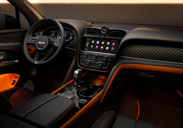 Interior front cabin view of Bentley Bentayga S, featuring Beluga leather and mandarin contrasting leather and Bentleys exclusive carbon weave on the dash fascia and in the door cards.