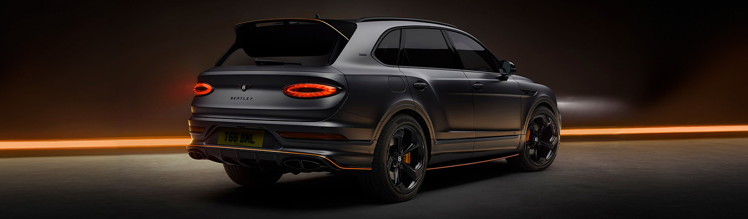 Bentley Bentayga S Black Edition rear 3/4 featuring 22 inch S directional wheel - Black Painted and Polished as well as Mandarin accents on the styling kit