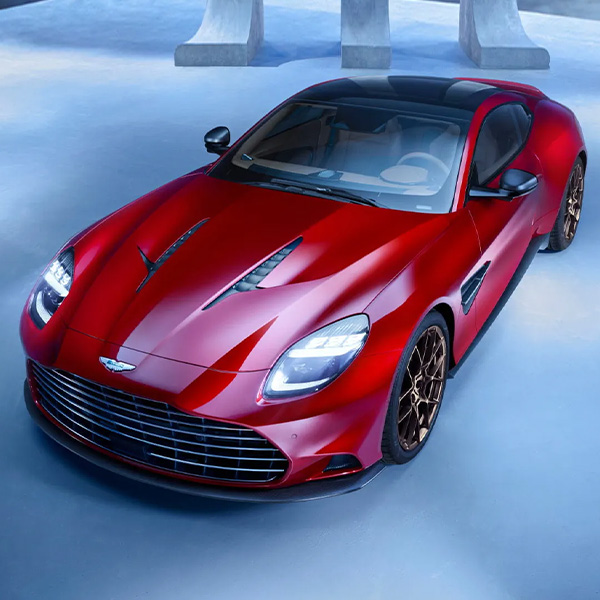 Red Aston Martin Vanquish parked in a modern studio setting