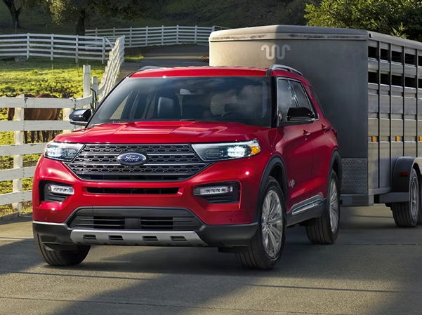 Red 2023 Ford Explorer towing a trailer