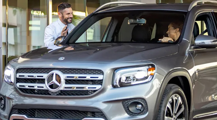 Dealership employee speaking to a customer