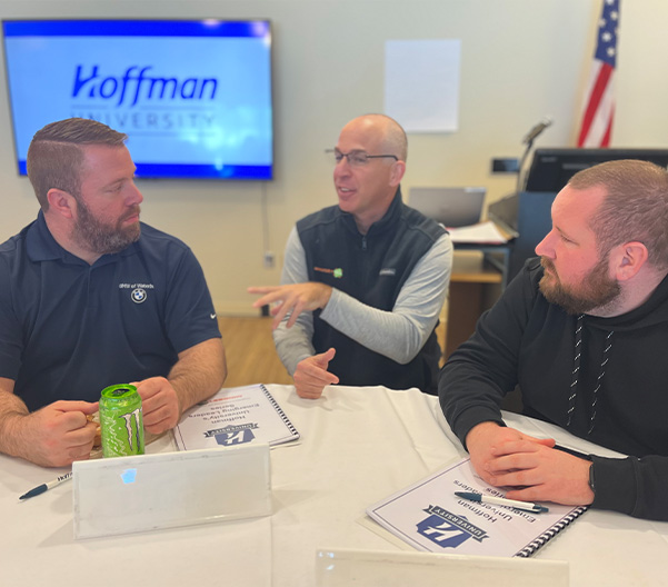 Hoffman employees networking around a table