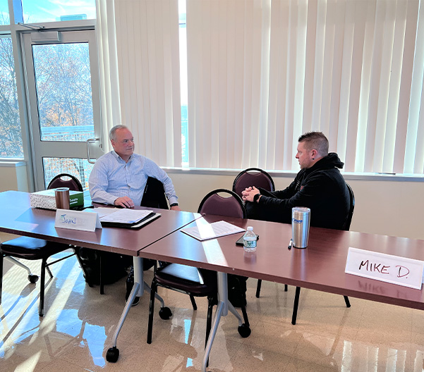 More Hoffman Leaders sitting at a desk strategizing