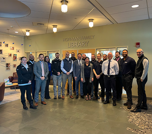 Group of Hoffman employees in a library posing for a picture