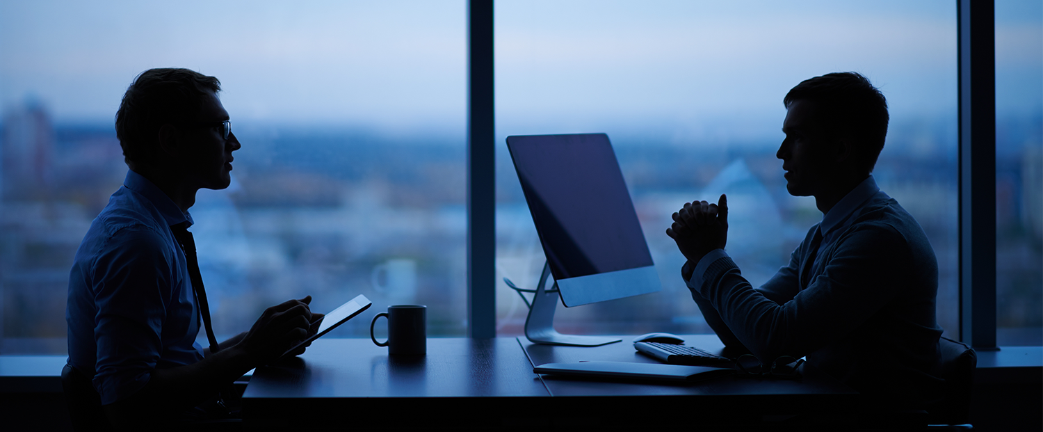 Teacher going over students notes on laptop