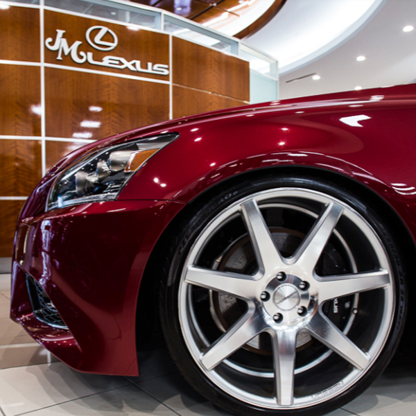 JM Lexus interior of dealership with wheel of Lexus car shown
