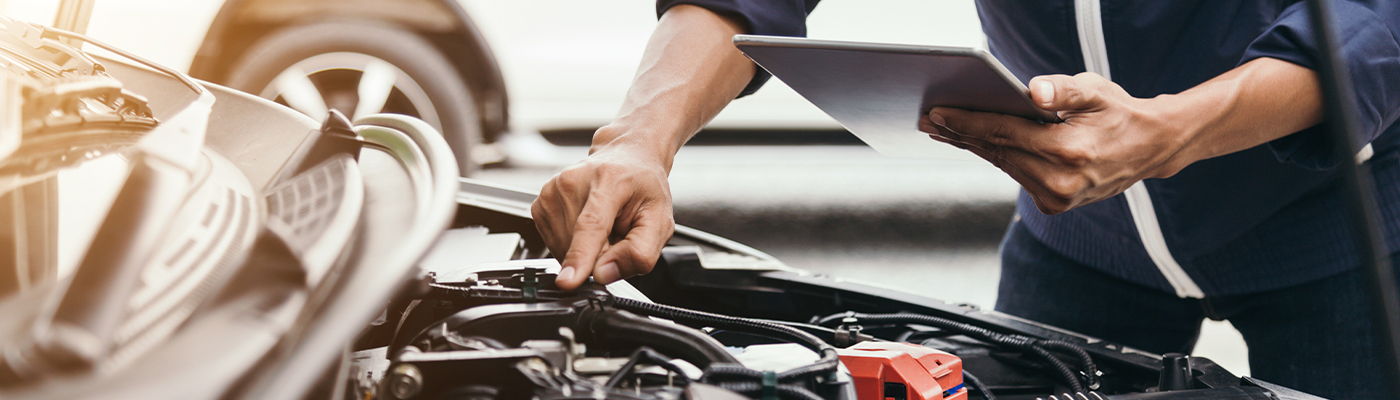 Service tech inspecting an engine